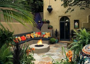 1 patio with plants colorful pillows and a fire pit
