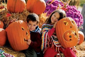 1 two children hugging some pumpkin jack o lanterns