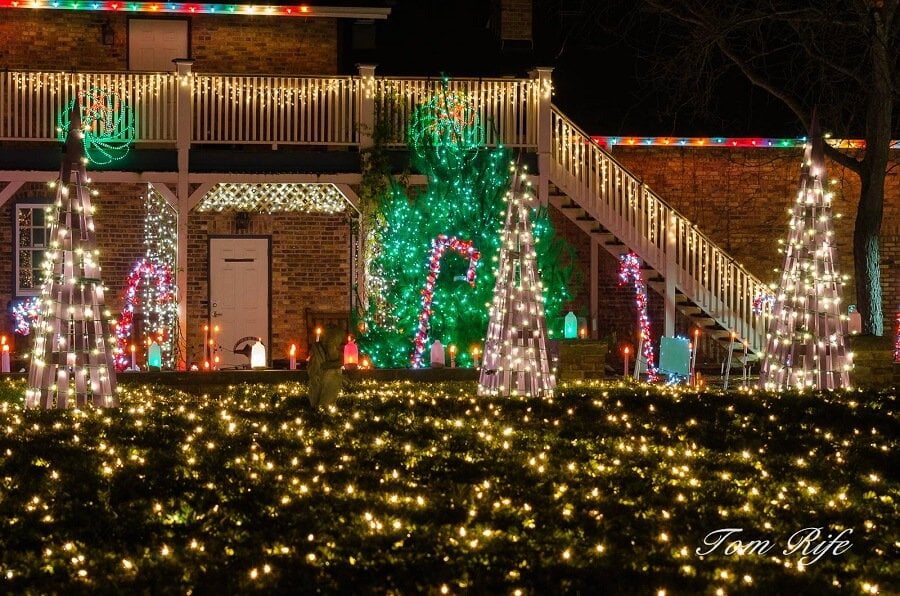 lawn and staircase covered in christmas lights