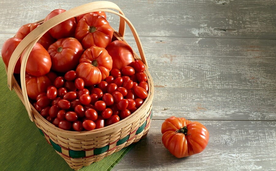 1 different types of tomatoes in a basket