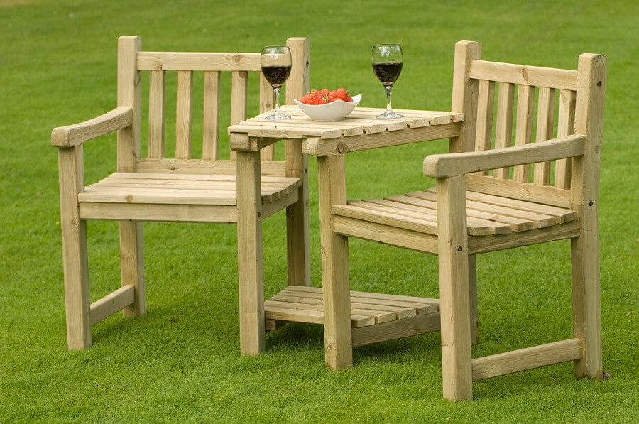 wooden chairs and table in the garden