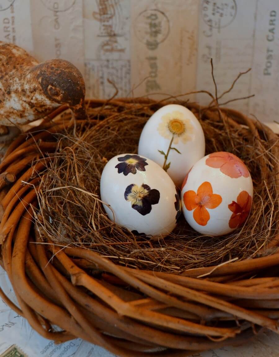 three eggs decorated with pressed flowers