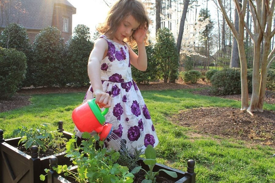 girl watering plants, keep gardening interesting