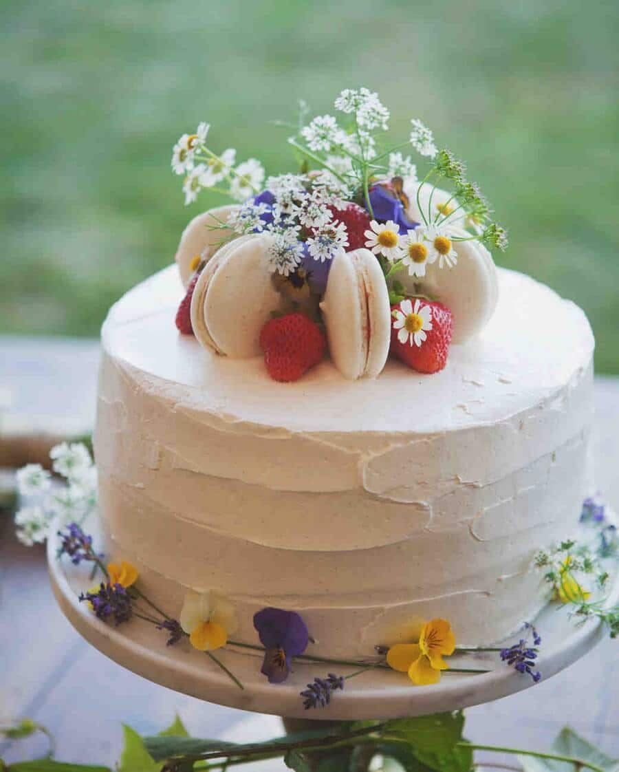 cake decorated with flowers and macarons, spring wedding ideas