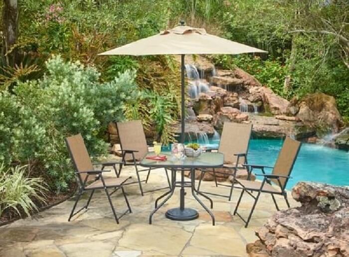 Mosaic dining furniture set placed next to a pond