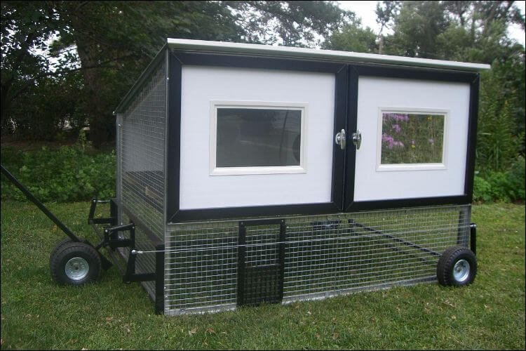 Customized black and white chicken coop, placed on wheels
