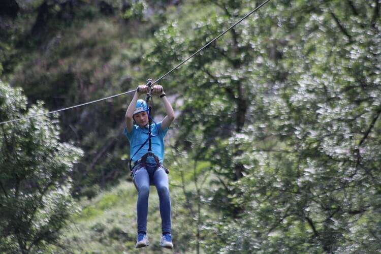 Woman ziplining in the forest