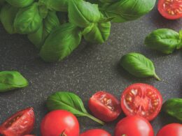 Photography of Tomatoes Near Basil Leaves