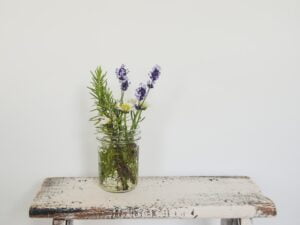 a vase of flowers sitting on top of a wooden table