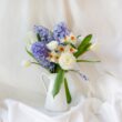 An image that captures the essence of a fading potted hyacinth, surrounded by withering petals, drooping leaves, and a delicate stalk, revealing the ephemeral beauty and transience of these fragrant flowers